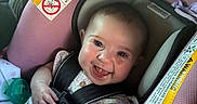 Rynleigh is registered to the contest to win money with this photo: baby, car_seat, child, smile, happy, infant, safety_harness, pink, clothing, cute, face, portrait, indoor, seat, child_safety, expression, person, closeup, skin, hand