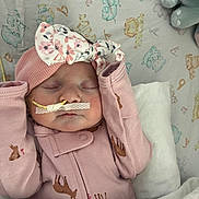 Rynleigh joined the competition — help win amazing prizes! baby, sleeping, pink_clothing, headband, floral_pattern, nasal_tube, blanket, animal_prints, deer_pattern, plush_toy, infant, child, cute, resting, indoors, soft_lighting, peaceful, toddler, face, bed