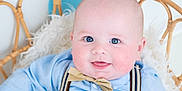 Graesyn joined the competition — help win amazing prizes! baby, child, smile, blue_eyes, bow_tie, suspenders, light_blue_shirt, beige_pants, wicker_chair, fluffy_cushion, indoor, portrait, happy, cute, infant, seated, pastel_background, closeup, plush, fashion