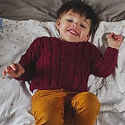 Luccian a rejoint le concours — aidez-le/la à gagner de superbes lots ! toddler, child, smiling, sweater, maroon, pants, mustard, blanket, lying_down, happy, indoor, face, person, clothing, cute, young, portrait, casual, relaxed, cozy