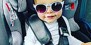 Luccian participe au concours pour gagner de l'argent avec cette photo : accessory, baby, black_pants, car_interior, car_seat, child, cute, face, fashion, hair, hand, indoors, patterned_pants, safety, seat, seatbelt, smile, sunglasses, toddler, white_shirt