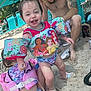 child, toddler, beach, sand, floaties, swimwear, disney_princess, umbrella, lounge_chair, tattoo, man, smile, happy, summer, vacation, outdoor, water_safety, family, play, footwear