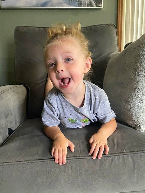 Nora is registered to the contest to win money with this photo: baby, baby_toddler_clothing, cheek, child, comfort, couch, face, floor, flooring, fun, hair, hairstyle, head, human_body, leg, person, skin, sleeve, smile, toddler