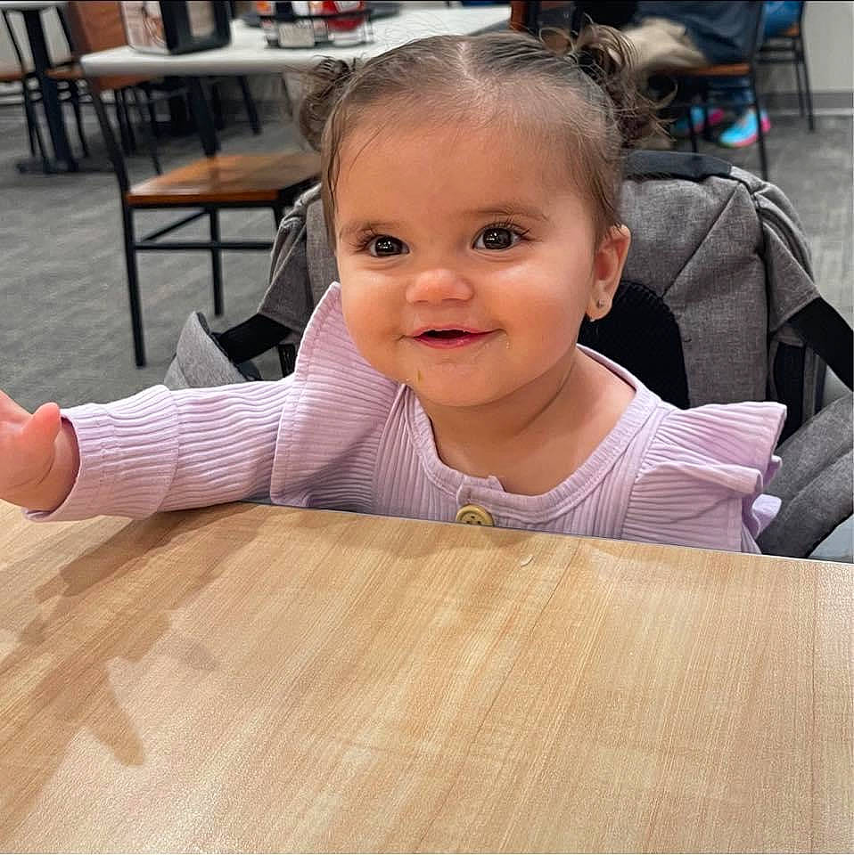 Kaycee is registered to the contest to win money with this photo: baby, baby_toddler_clothing, chair, cheek, child, floor, flooring, fun, happy, hardwood, joy, person, sitting, skin, smile, table, thumb, toddler, varnish, wood