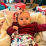Addison is registered to the contest to win money with this photo: baby, blanket, carpet, casual, child, clothing, comfort, cute, expression, face, floral, headband, home, indoor, infant, living_room, people, person, seated, soft