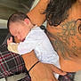 Eli joined the competition — help win amazing prizes! baby, sleeping, infant, person, tattoo, arm, hand, plaid_pants, clothing, skin, closeup, indoor, rest, peaceful, newborn, holding, comfort, face, hair, couch