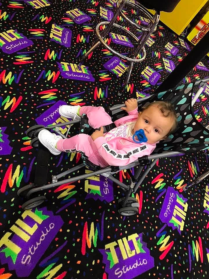 Keilani is registered to the contest to win money with this photo: art, baby, baby_toddler_clothing, entertainment, event, magenta, pattern, person, pink, purple, toddler
