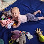 baby, infant, blanket, toy, plush_toy, rattle, headband, smile, child, floor, cute, clothing, pink, purple, blue, patterned_pants, lying_down, indoors, playtime, happy