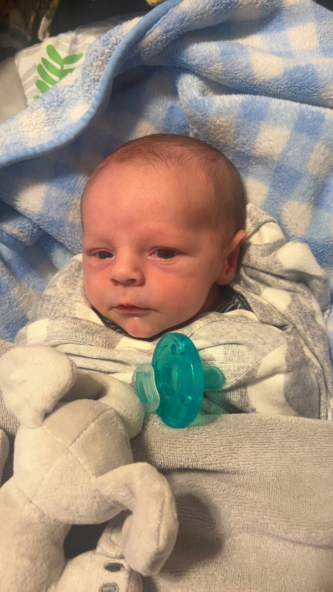 Carter joined the competition — help win amazing prizes! baby, blanket, blue, pacifier, plush_toy, infant, wrapped, sleepwear, soft_toy, face, newborn, lying_down, closeup, comfort, child, cute, resting, indoors, portrait, toddler