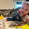 Koa joined the competition — help win amazing prizes! baby, child, smiling, crib, overalls, toy, bed, indoor, playful, happy, person, infant, colorful, furniture, face, room, clothing, cute, expression, young