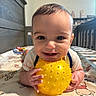 Koa is registered to the contest to win money with this photo: baby, child, infant, yellow_ball, toy, bed, crib, smiling, happy, cute, face, hands, nursery, indoor, clothing, play, closeup, person, portrait, toddler