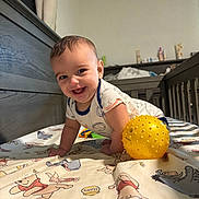 Koa joined the competition — help win amazing prizes! baby, smiling, crawling, crib, yellow_ball, bedspread, winnie_the_pooh, indoor, child, happy, toy, infant, cute, person, furniture, wooden_crib, playtime, portrait, toddler, clothing