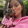 Belly participe au concours pour gagner de l'argent avec cette photo : woman, dog, puppy, dachshund, pink_hoodie, pink_clothing, outdoor, tree, greenery, affection, pet, cute, portrait, closeup, hand, face, earrings, nature, casual, love