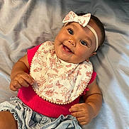 Oaklee joined the competition — help win amazing prizes! accessories, baby, clothing, couch, cushion, dress, face, furniture, happy, hat, head, headband, jewelry, laughing, necklace, person, photography, portrait, sitting, smile