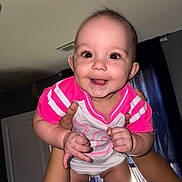Vanessa joined the competition — help win amazing prizes! baby, child, smile, happy, face, person, arms, hands, indoors, curtains, window, clothing, pink, white, skin, portrait, cute, infant, joy, holding