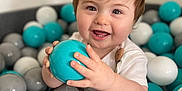 Luca is registered to the contest to win money with this photo: baby, ball, balloon, bodypart, face, finger, football, hand, happy, head, person, photography, portrait, sitting, smile, soccer, soccerball, sphere, sport, turquoise
