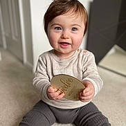 Luca joined the competition — help win amazing prizes! baby, bodypart, clothing, face, finger, hand, happy, head, indoors, jeans, pants, person, photography, portrait, reading, sitting, sleeve, smile, t_shirt, text