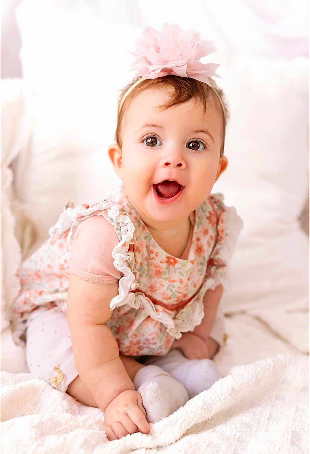 Addie joined the competition — help win amazing prizes! baby, child, smiling, happy, headband, flower, dress, pink, white, blanket, soft, cute, sitting, indoors, portrait, infant, clothing, person, toddler, closeup