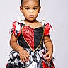 toddler, child, portrait, costume, queen_of_hearts, dress, red, black, white, curly_hair, studio, serious, fashion, young_girl, earrings, posing, isolated, cute, girl, studio_lighting