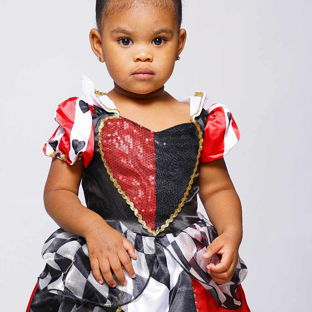Myla joined the competition — help win amazing prizes! toddler, child, portrait, costume, queen_of_hearts, dress, red, black, white, curly_hair, studio, serious, fashion, young_girl, earrings, posing, isolated, cute, girl, studio_lighting