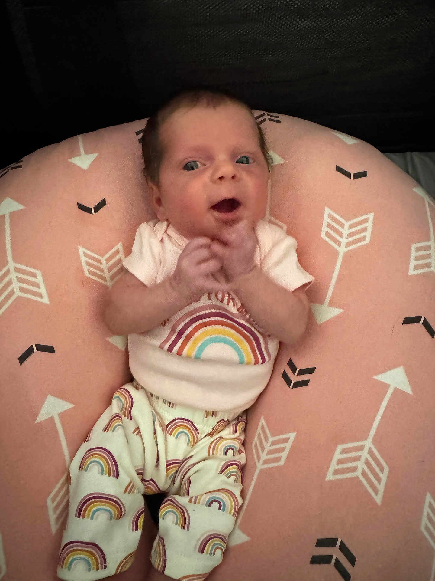 Addilynn joined the competition — help win amazing prizes! baby, infant, rainbow, cushion, pink, arrows, clothing, newborn, cute, hands, face, expression, lying_down, soft, pattern, child, person, apparel, indoors, comfort