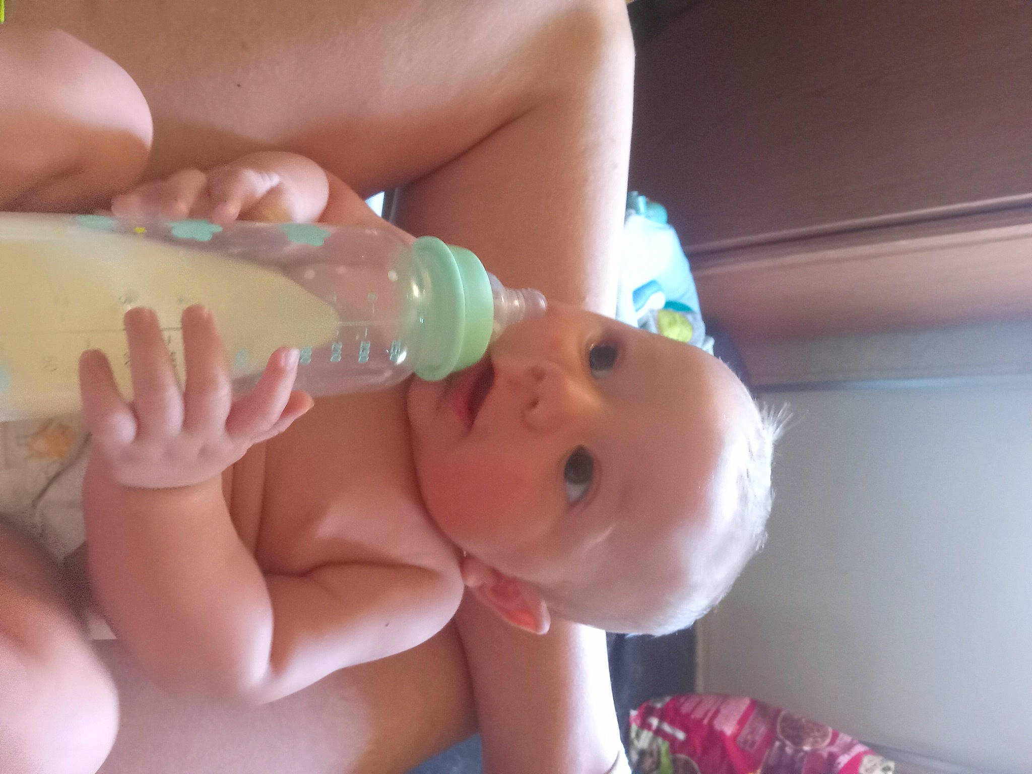 Axl is registered to the contest to win money with this photo: baby, baby_bottle, bottle, cheek, drinkware, finger, gesture, hand, happy, head, human_body, lip, liquid, mouth, nail, nose, person, skin, thumb, toddler