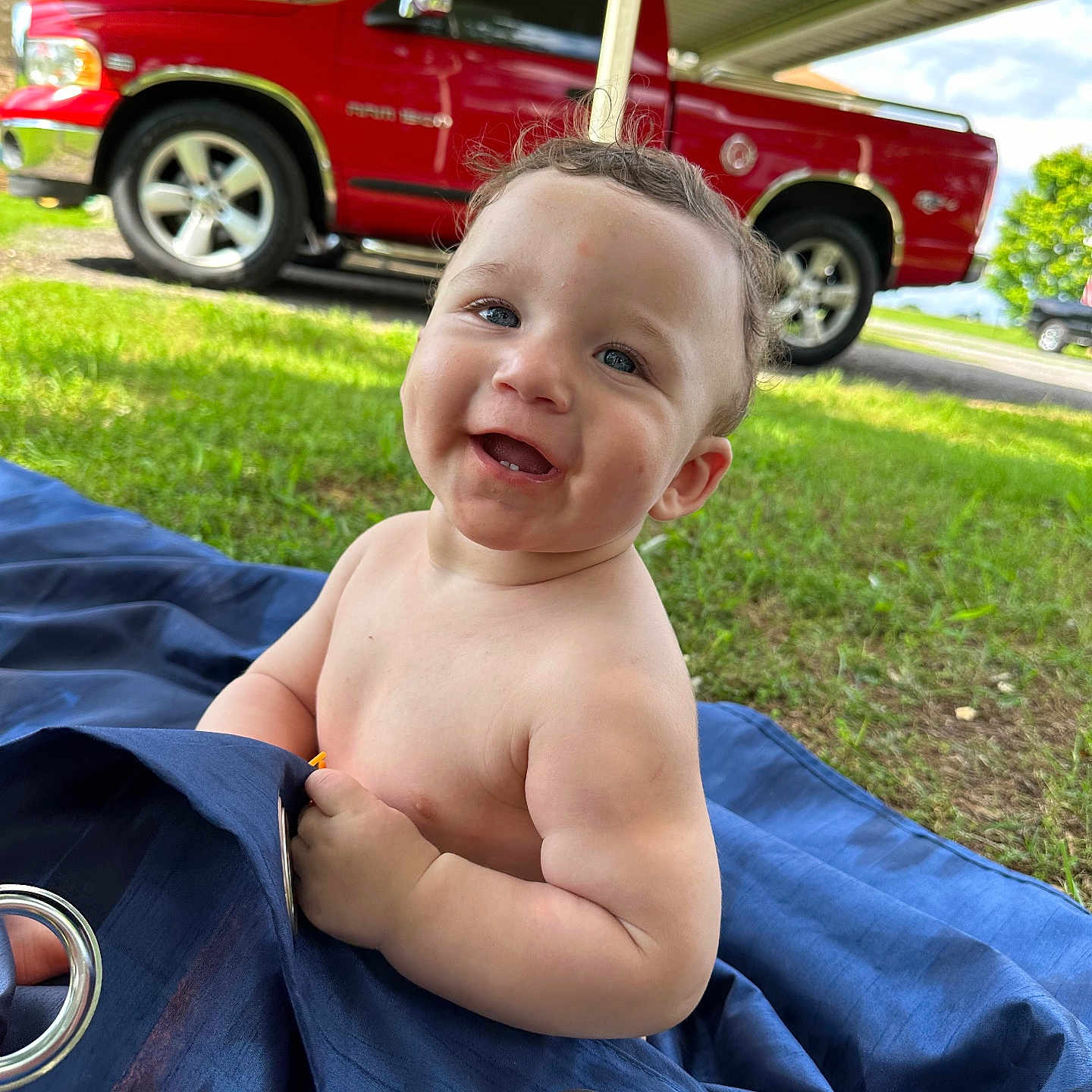 Kyson is registered to the contest to win money with this photo: alloywheel, baby, car, carwheel, face, grass, head, machine, person, photography, pickuptruck, plant, portrait, spoke, suv, tire, transportation, truck, vehicle, wheel