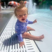 Sophia Grace joined the competition — help win amazing prizes! toddler, child, pool, water, swimsuit, sitting, smiling, hair, sunny, outdoor, summer, playful, happy, water_fountain, blue_sky, umbrella, recreation, vacation, fun, baby