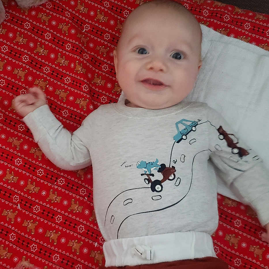 Isaiah is registered to the contest to win money with this photo: applique, baby, bed, bodypart, clothing, crib, cushion, face, finger, furniture, hand, head, homedecor, infantbed, pants, pattern, person, photography, portrait, t_shirt