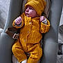 baby, infant, knitwear, yellow_clothing, hat, pacifier, baby_seat, white_socks, floor, wooden_floor, indoor, cute, child, portrait, person, newborn, cozy, warm_clothing, resting, looking_away
