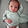 baby, newborn, infant, diaper, onesie, hand, face, eyes, lying_down, quilted_surface, clothing, cute, small, skin, human, child, portrait, baby_girl, baby_boy, resting