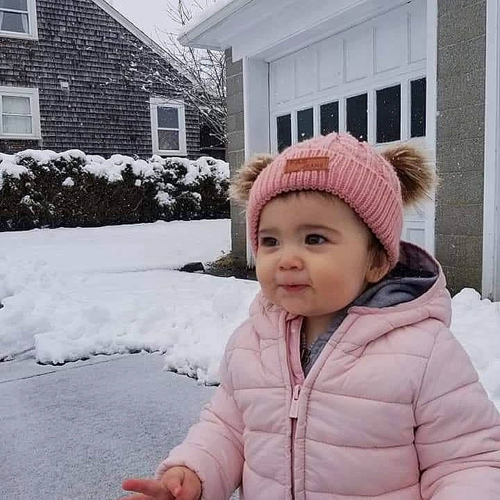 Edith joined the competition — help win amazing prizes! beanie, cap, child, fashion_accessory, freezing, frost, fun, fur, grass, headwear, house, jacket, knit_cap, person, photograph, plant, playing_in_the_snow, snow, toddler, tree