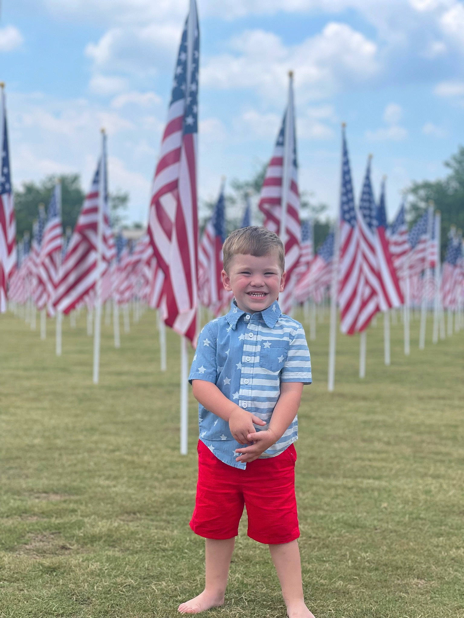 Carson joined the competition — help win amazing prizes! cloud, cumulus, event, flag, flag_day_usa, flag_of_the_united_states, fun, gesture, grass, grassland, holiday, joy, person, pole, recreation, shorts, sky, smile, soldier, summer