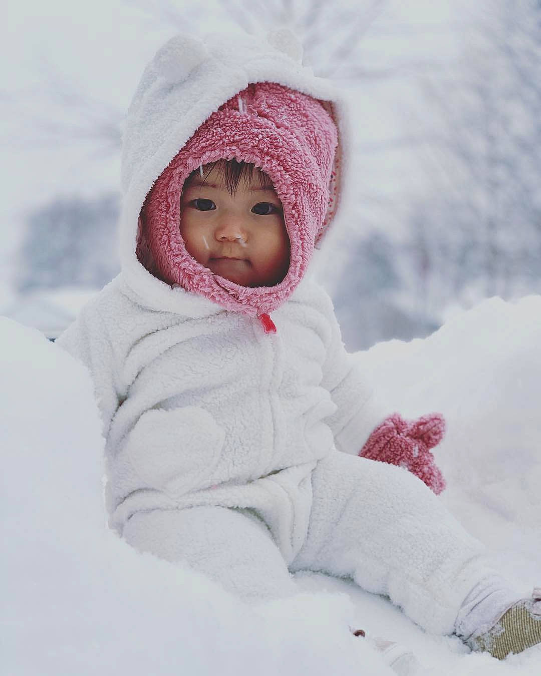 Karissa is registered to the contest to win money with this photo: baby, bonnet, cheek, child, freezing, fun, head, headgear, headwear, knit_cap, outerwear, person, pink, playing_in_the_snow, skin, smile, snow, toddler, white, winter