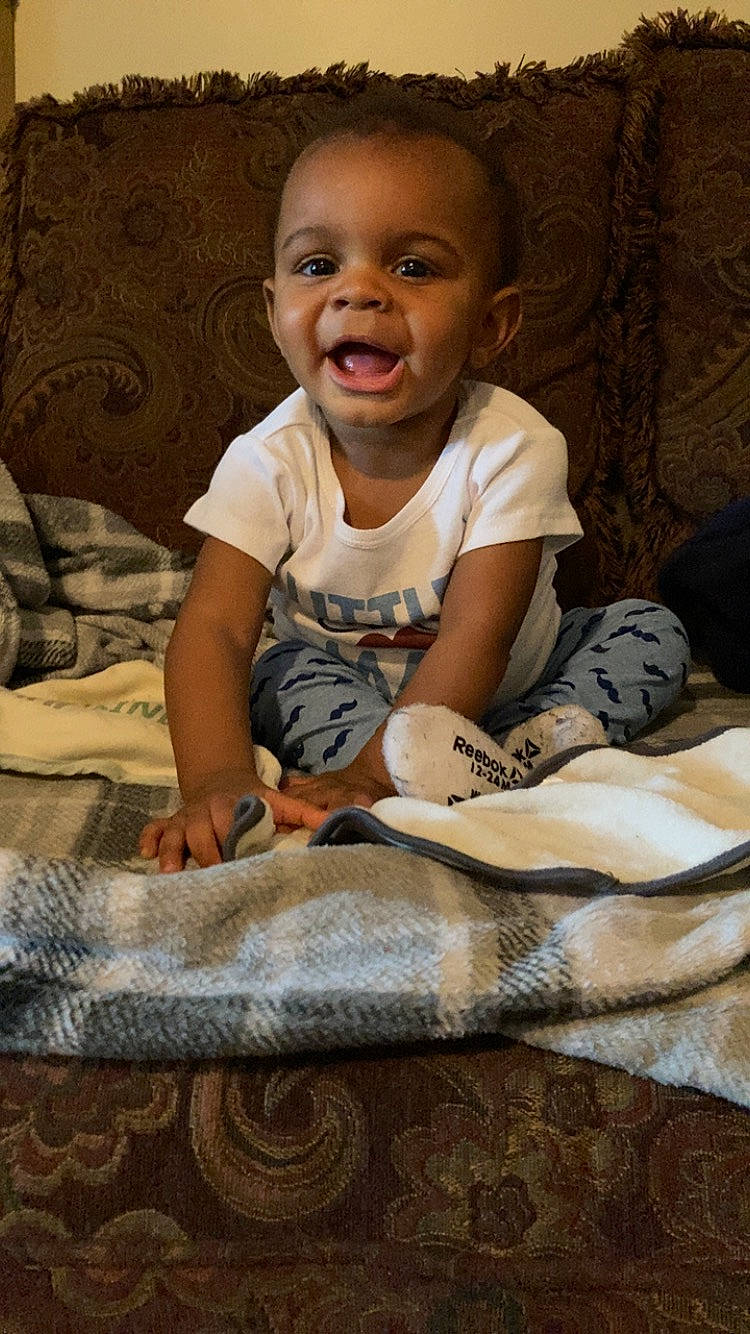 Dallas joined the competition — help win amazing prizes! baby, baby_toddler_clothing, bedding, carpet, child, comfort, flash_photography, floor, flooring, fun, happy, linens, pattern, person, portrait_photography, room, sitting, smile, t_shirt, toddler