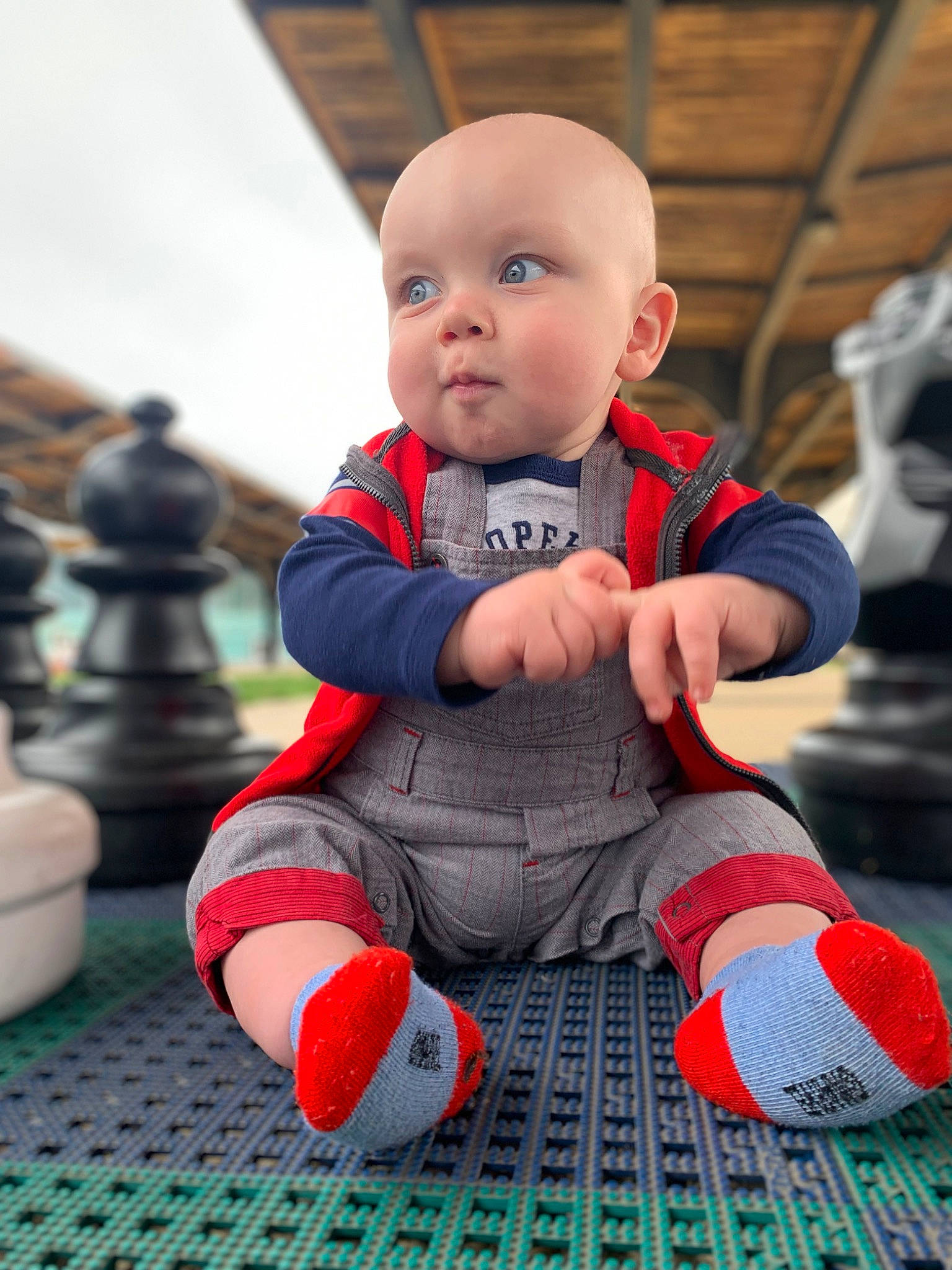Felix is registered to the contest to win money with this photo: baby, baby_toddler_clothing, carmine, child, fictional_character, flooring, fun, grass, happy, human_leg, leisure, orange, pattern, people, person, personal_protective_equipment, play, recreation, sitting, standing