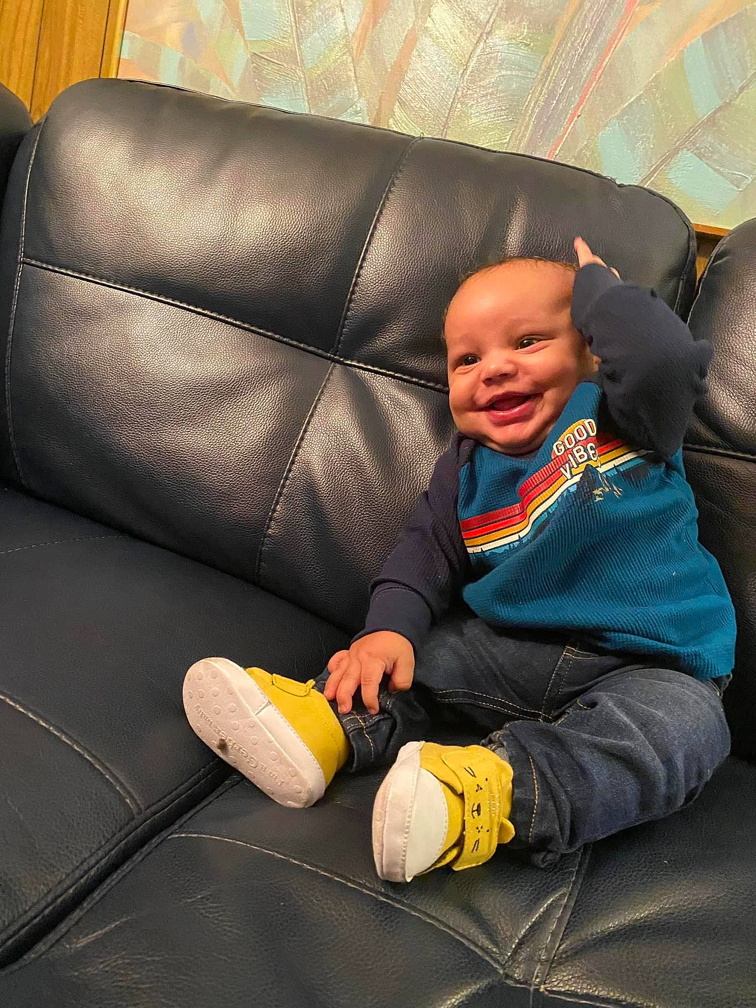 Ronnell is registered to the contest to win money with this photo: auto_part, baby, car_seat, comfort, couch, family_car, finger, human_body, human_leg, joy, lap, orange, person, shoe, sitting, smile, sneakers, textile, thumb, toddler