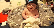 Cylis joined the competition — help win amazing prizes! baby, infant, beanie, hat, pillow, bed, blanket, dinosaur_pattern, room, caps, valentines_day_card, stuffed_animal, toys, clothing, face, child, indoor, person, cozy, home