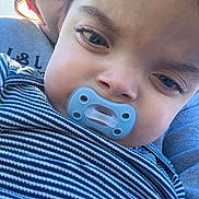 Harvee is registered to the contest to win money with this photo: baby, child, toddler, infant, pacifier, striped_wrap, close_up, portrait, face, eyes, sleepy, cuddling, 抱, blue, clothing, fabric, outdoor, natural_light, photobomb, family
