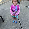 child, girl, smiling, outdoor, portrait, backpack, pink_clothing, barbie, hoodie, shorts, sneakers, school, sidewalk, playground, people, standing, blonde_hair, blue_eyes, daylight, summer