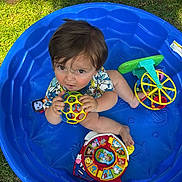 Michael joined the competition — help win amazing prizes! toddler, child, blue_pool, toy_ball, colorful_toys, grass, outdoor, playing, summer, plastic_pool, curious, looking_up, short_hair, casual_clothing, daylight, barefoot, happy, fun, baby, playtime