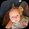 Braxton is registered to the contest to win money with this photo: baby, child, infant, face, eyes, hair, mohawk, tattoo, arm, couch, clothing, person, indoor, portrait, curious, cute, skin, sitting, closeup, young