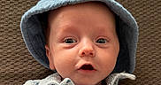 Braxton joined the competition — help win amazing prizes! baby, infant, face, hat, clothing, blue_hat, expression, texture, blanket, portrait, cute, wide_eyes, mouth_open, indoor, child, young_child, closeup, skin, headwear, person