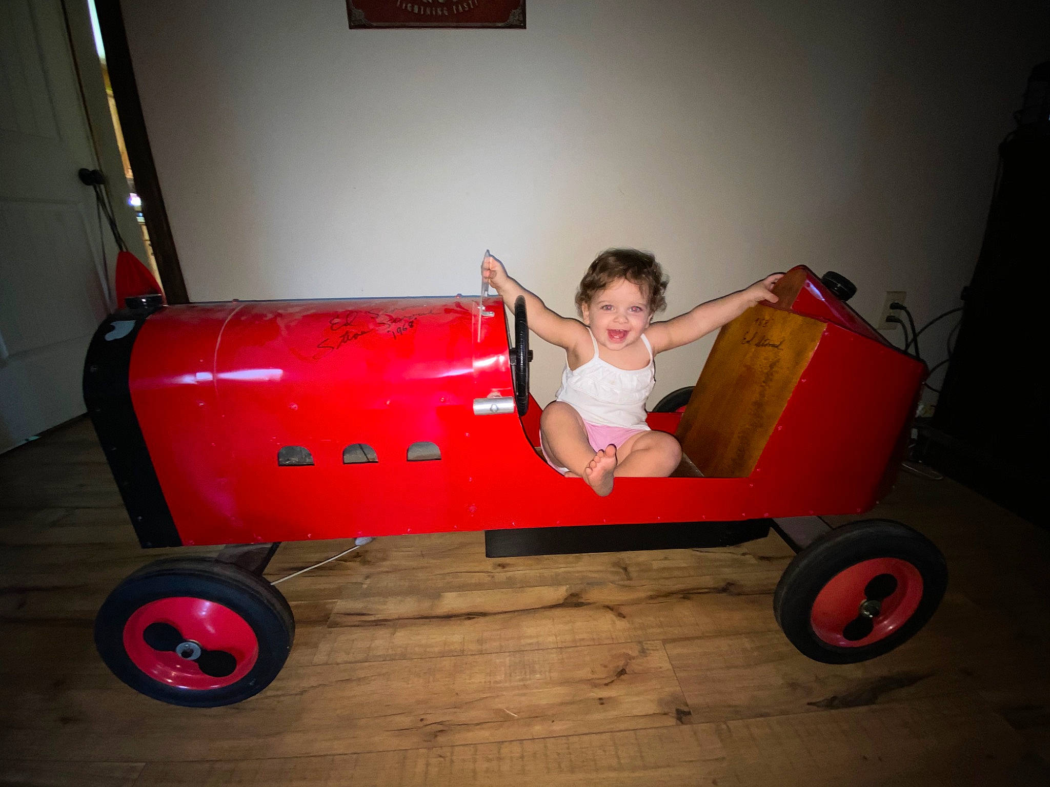 Josephine is registered to the contest to win money with this photo: auto_part, automotive_design, automotive_tire, automotive_wheel_system, cart, floor, flooring, fun, joy, motor_vehicle, person, riding_toy, rim, rolling, sitting, tire, toddler, tread, vehicle, wheel