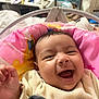 baby, smiling, infant, pink_cushion, colorful, cozy_clothing, happy, face, mouth_open, hand, indoor, bedroom, blanket, child, cute, young, soft, portrait, person, joyful