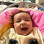 baby, smiling, infant, pink_cushion, baby_seat, clothing, indoor, happy, face, person, child, cute, cozy, soft_toy, home, expression, portrait, young, seat, wearing