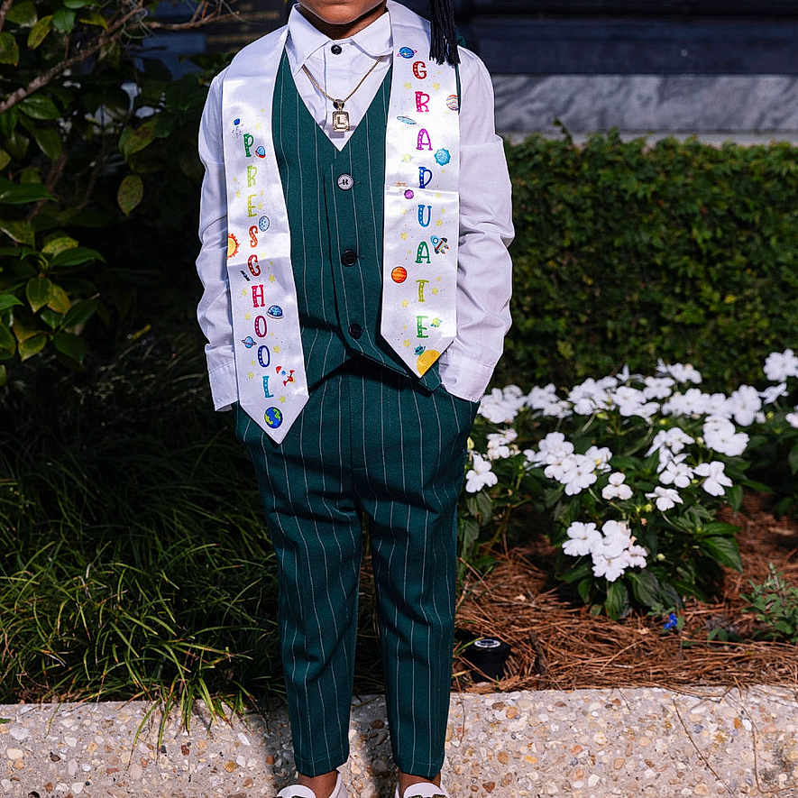 Lester V joined the competition — help win amazing prizes! boy, cap, celebration, child, flowers, formal_wear, graduate, graduation, greenery, happy, outdoor, portrait, preschool, sash, shoes, smiling, standing, suit, vest, white_shirt