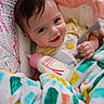 Mia is registered to the contest to win money with this photo: baby, bottle, blanket, smile, infant, cute, child, face, happy, indoors, soft, colorful, cozy, clothing, person, portrait, baby_bottle, baby_clothes, expression, warm
