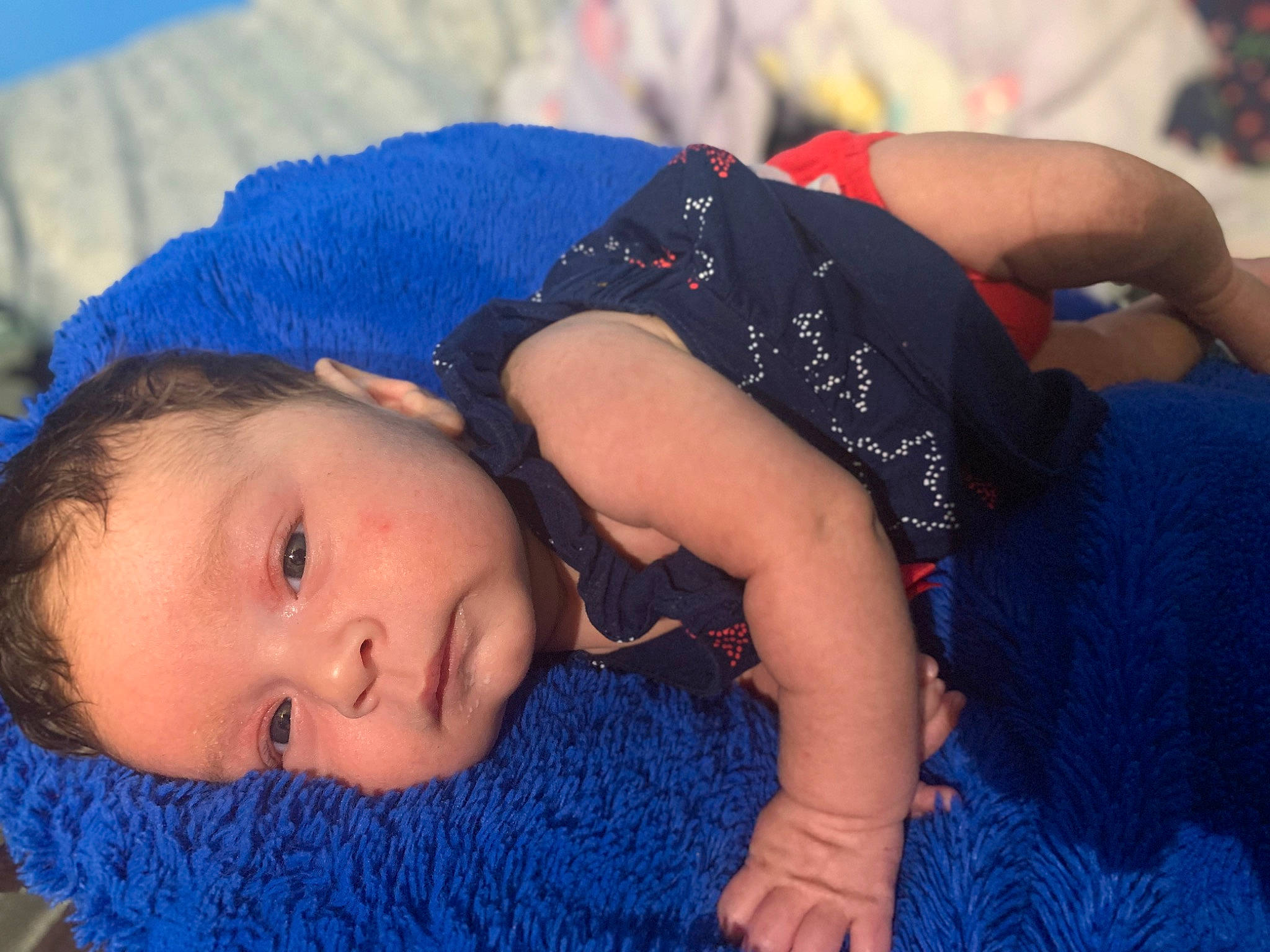 Aurelia is registered to the contest to win money with this photo: abdomen, baby_toddler_clothing, blue, child, electric_blue, fashion_accessory, fun, grass, happy, headgear, human_leg, leisure, pattern, person, sand, sitting, textile, thigh, toddler, trunk