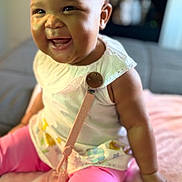 Kru joined the competition — help win amazing prizes! baby, child, smiling, sitting, indoor, pink_leggings, white_top, pacifier_clip, blanket, bow, happy, cute, infant, portrait, young_child, face, skin, hand, leg, clothing